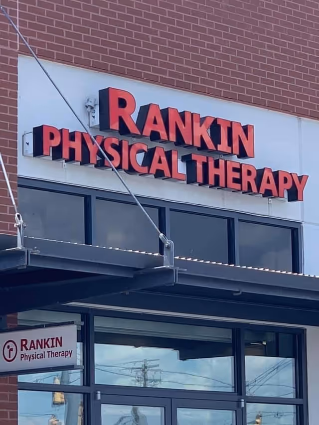 Exterior view of Rankin Physical Therapy storefront sign on a brick building.