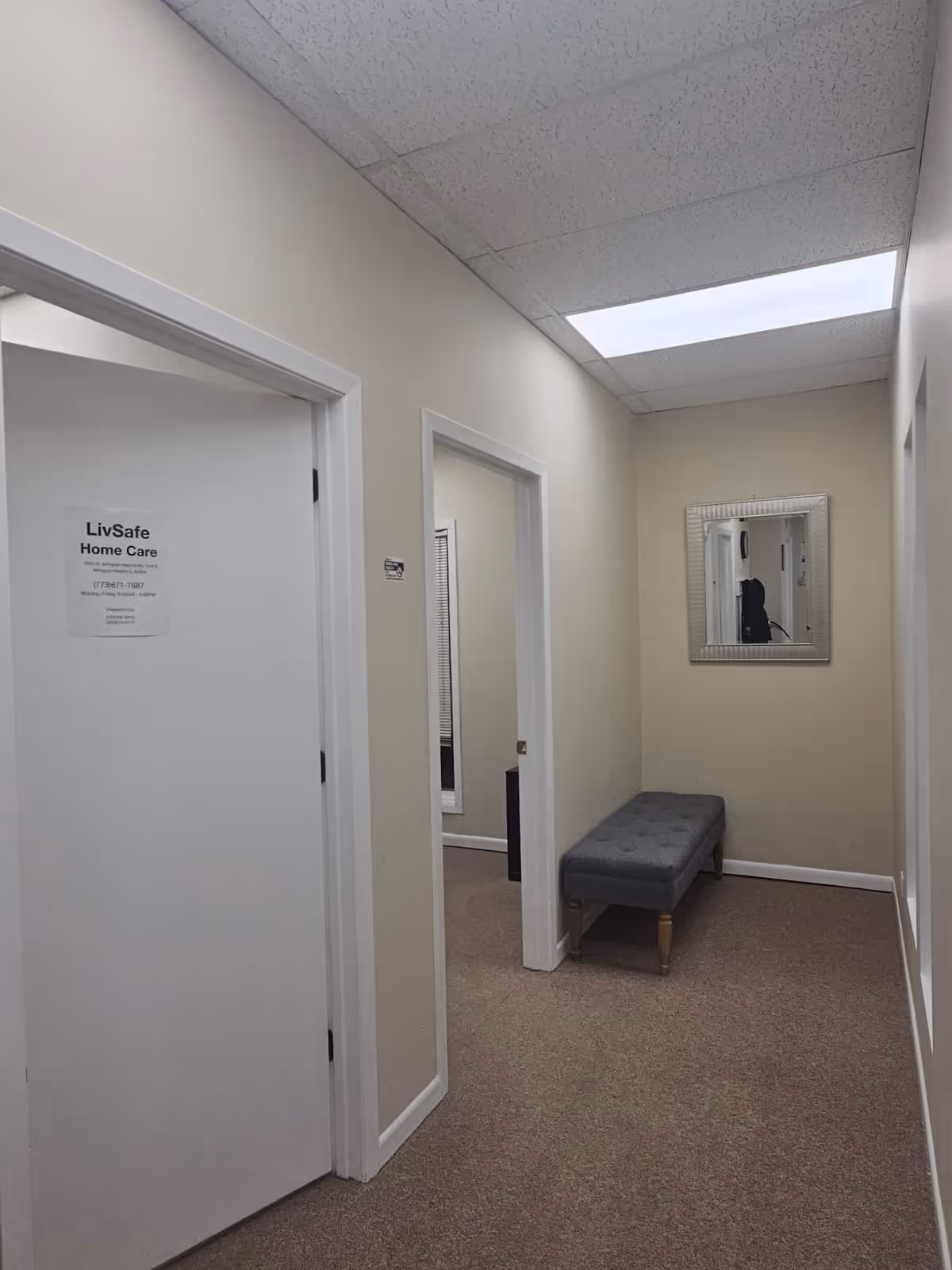 Interior hallway at LivSafe Home Care with a bench and wall mirror