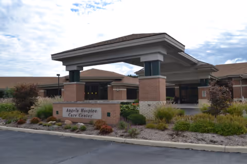 Exterior view of Angela Hospice Care Center entrance with a covered porte-cochere.