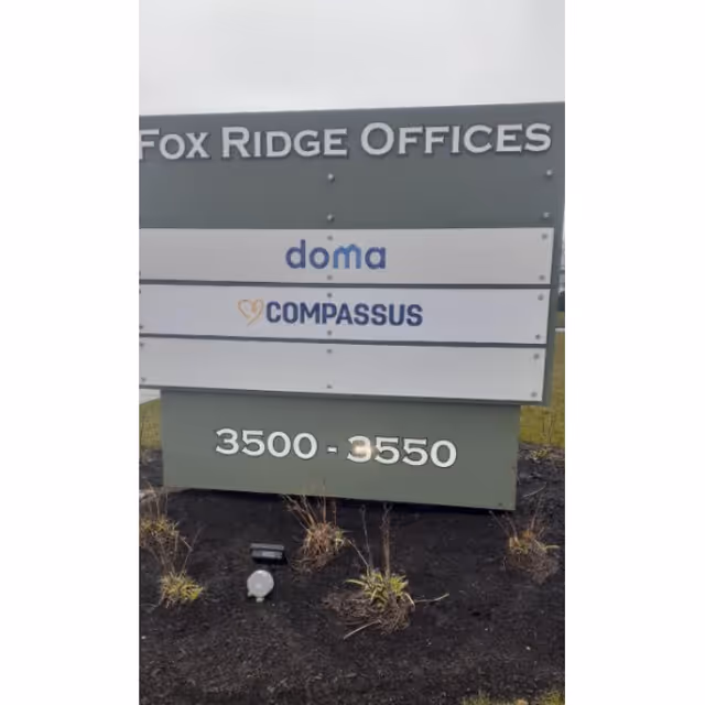 Outdoor signboard displaying Fox Ridge Offices with Doma and Compassus logos.