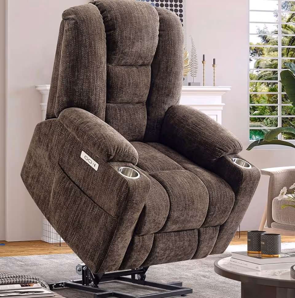 Brown upholstered reclining chair in a bright living room with window and plants.