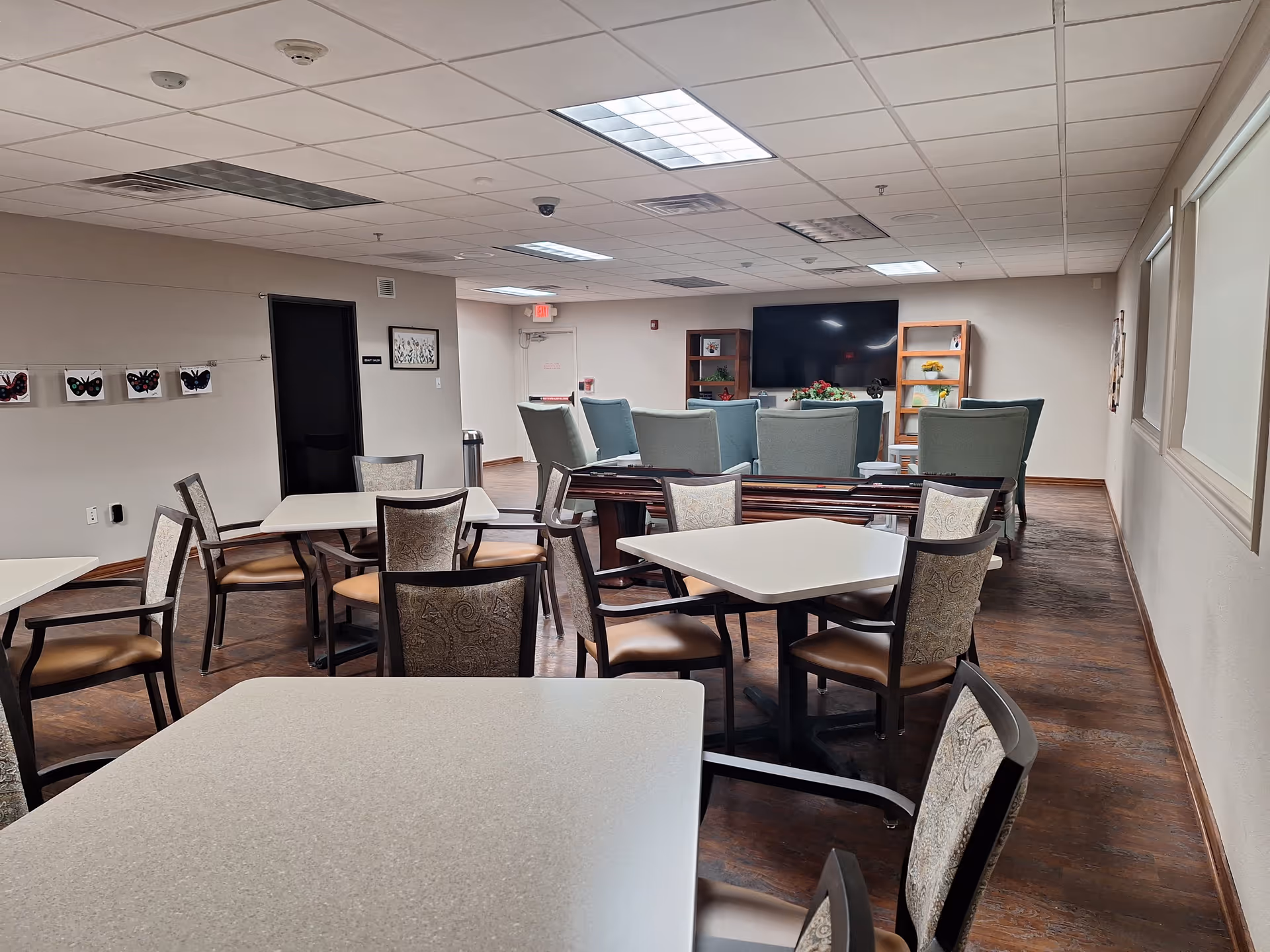 Spacious common area with tables, chairs, and a lounge seating area.
