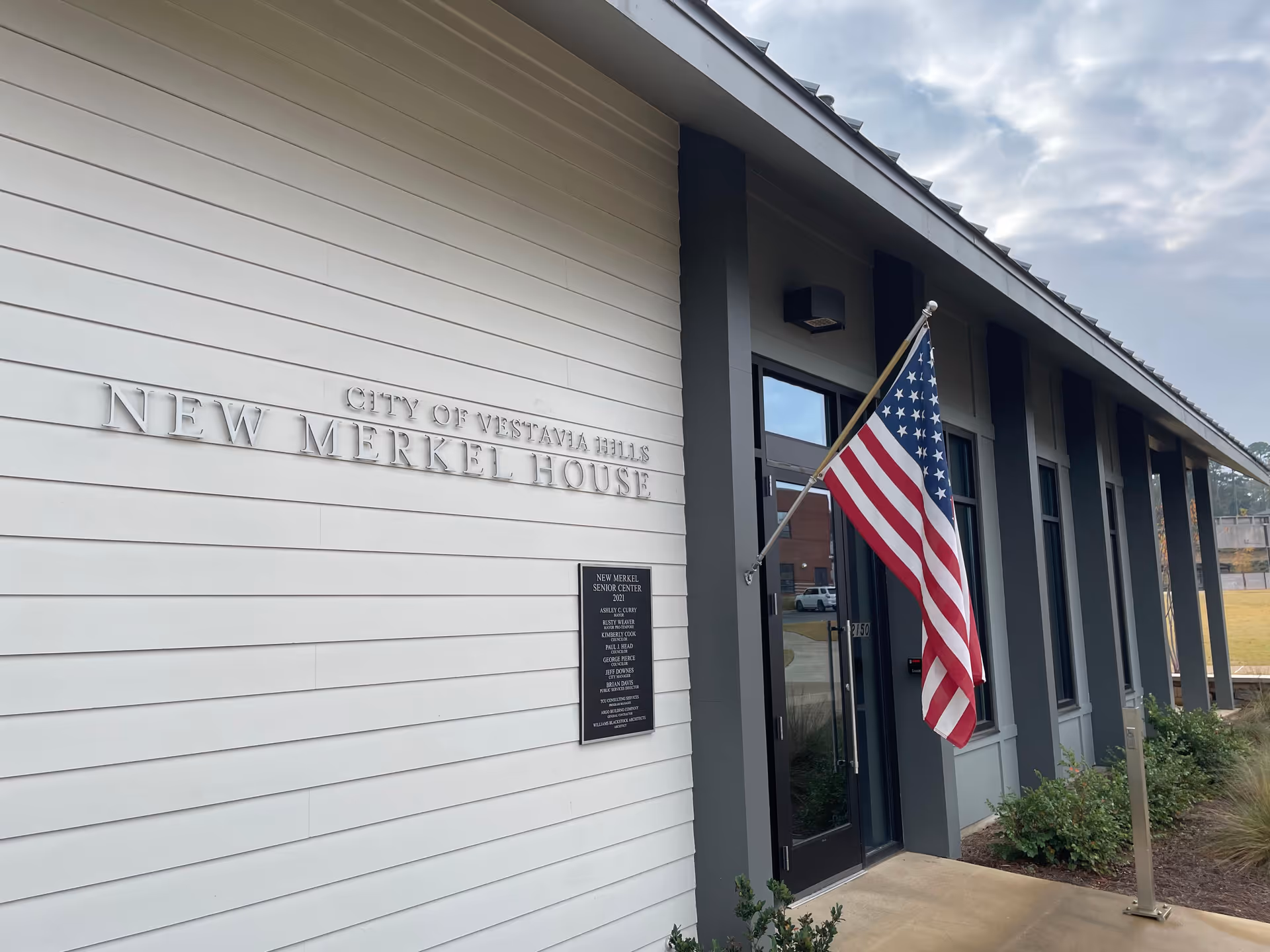 Exterior of Cornerstone Caregiving building with American flag at the entrance.