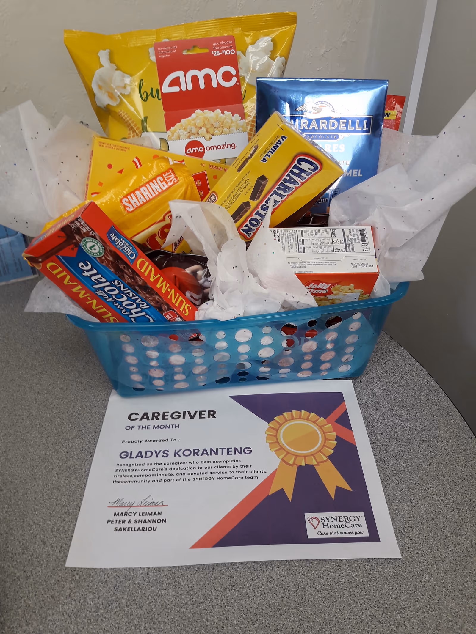 Snack basket and Caregiver of the Month certificate on a table in an interior setting.