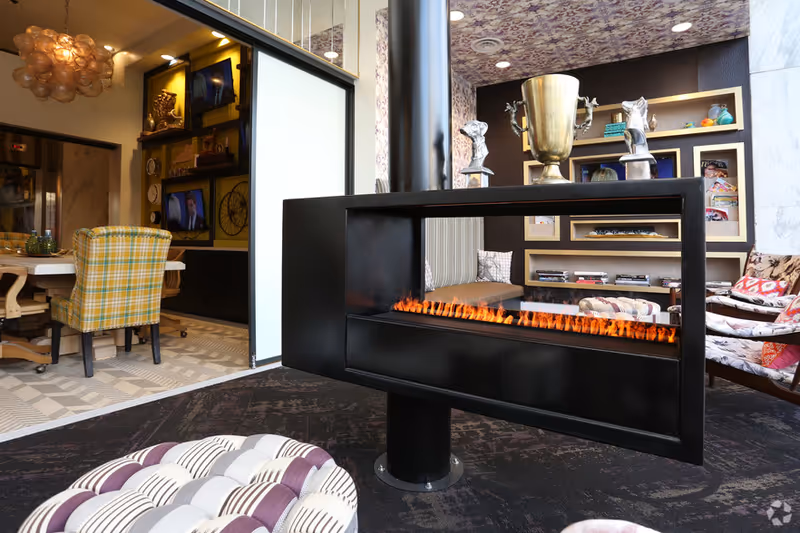 Modern living area inside Serenity Home Care with a fireplace, stylish seating, and display shelves.