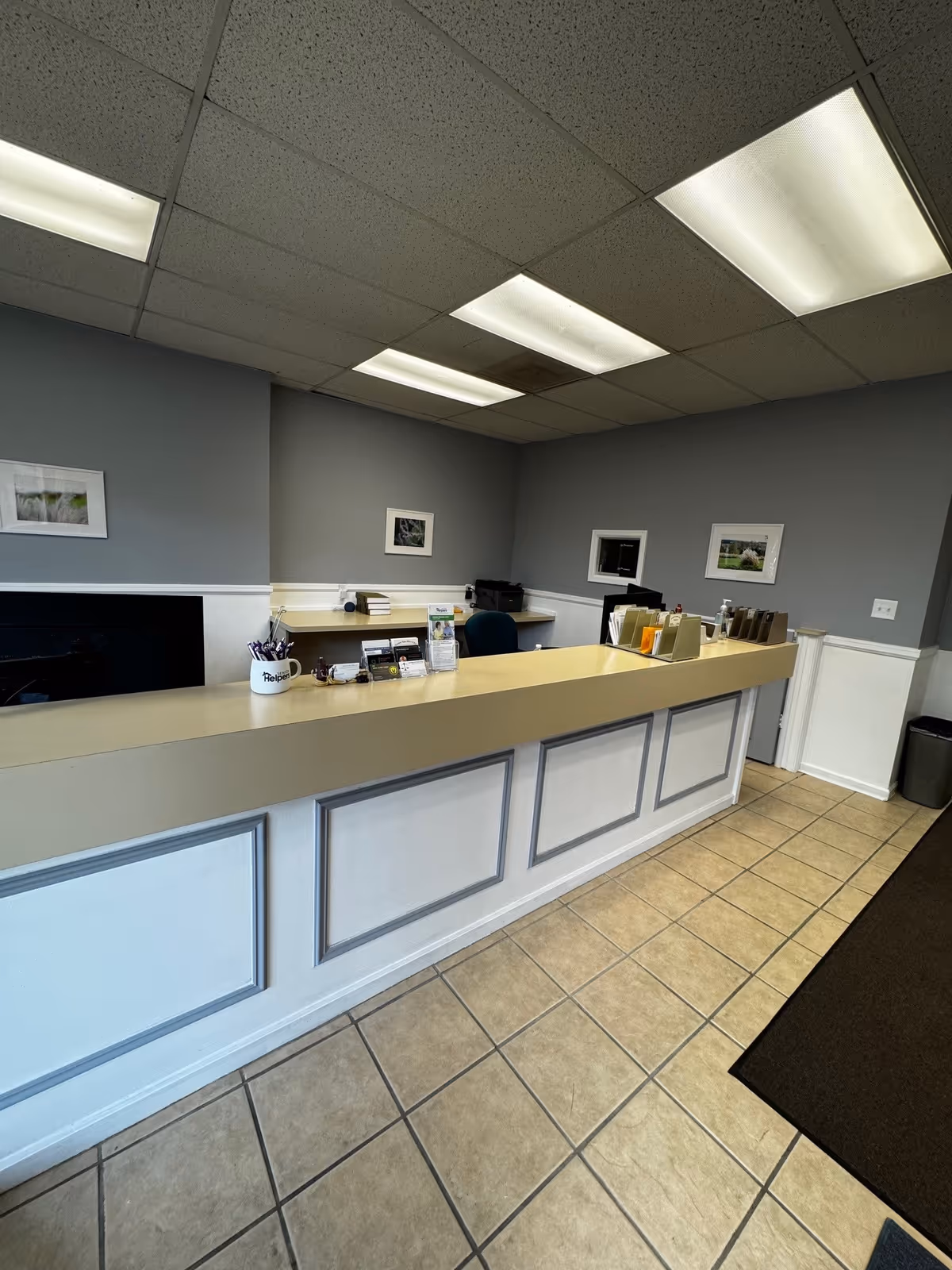 Interior view of a reception desk in a senior living facility lobby.