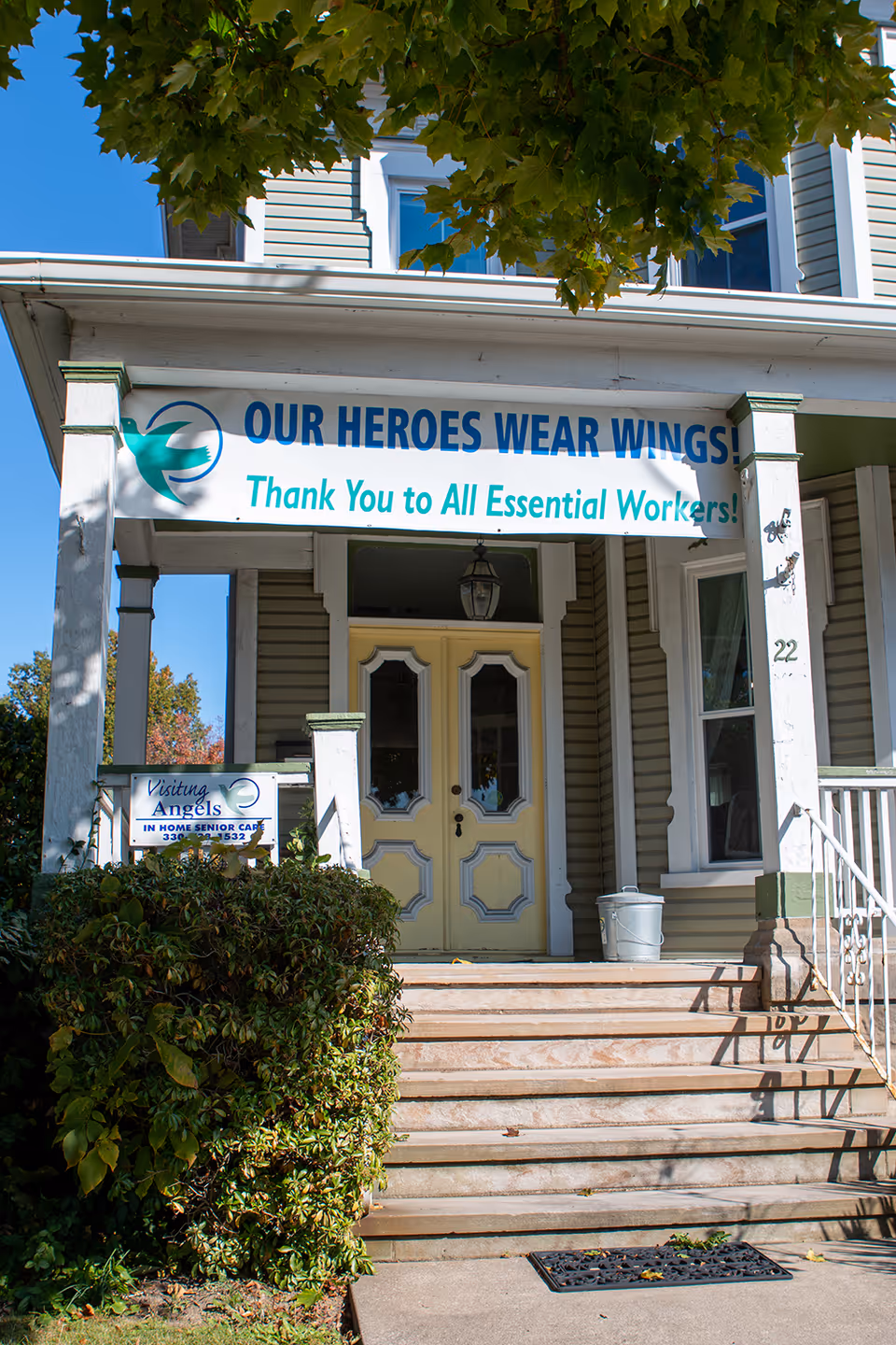 Front entrance of Visiting Angels Senior Home Care with banner and steps.