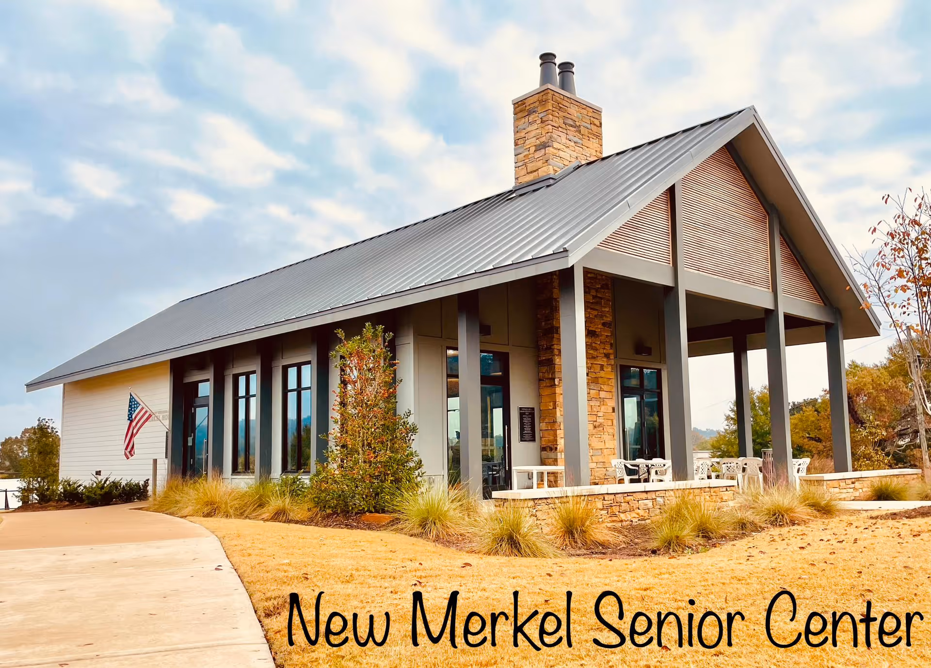 Modern senior center with stone columns, large windows, and outdoor seating.