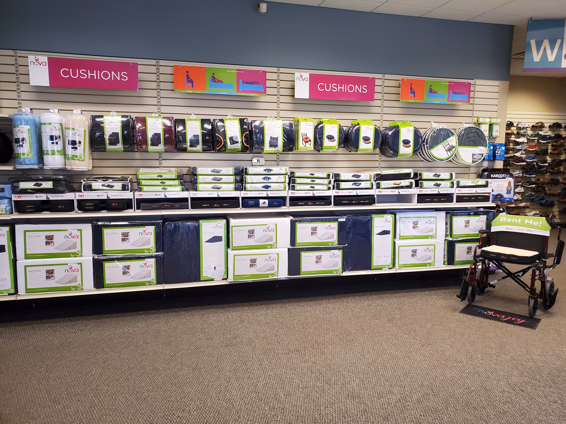 Store aisle with cushions and mobility aids on shelves, wheelchair in foreground