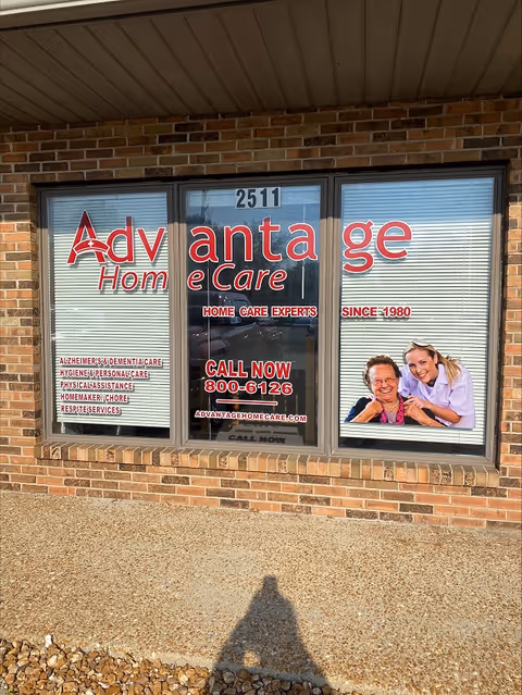 Front of Advantage Home Care storefront with large window sign and caregiver image.