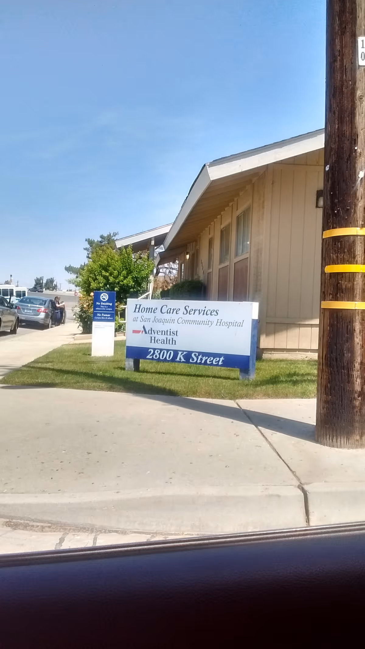 Exterior view of a beige building with a blue Adventist Health Home Care Services sign.