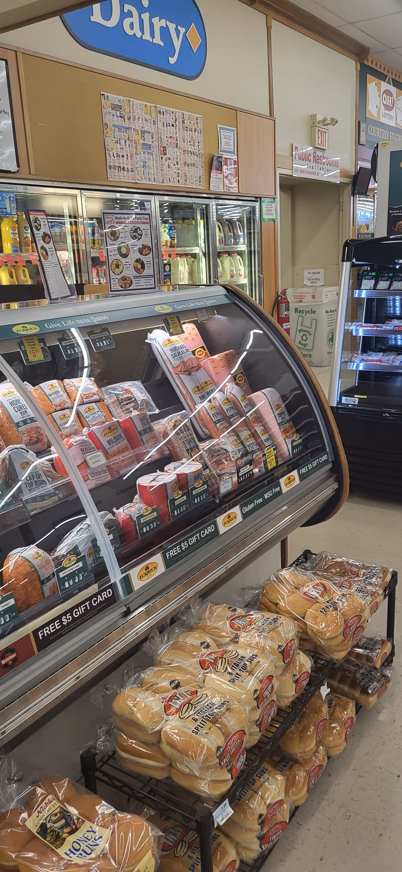 Inside Discount Drug Mart, a curved meat display case and bread shelves.