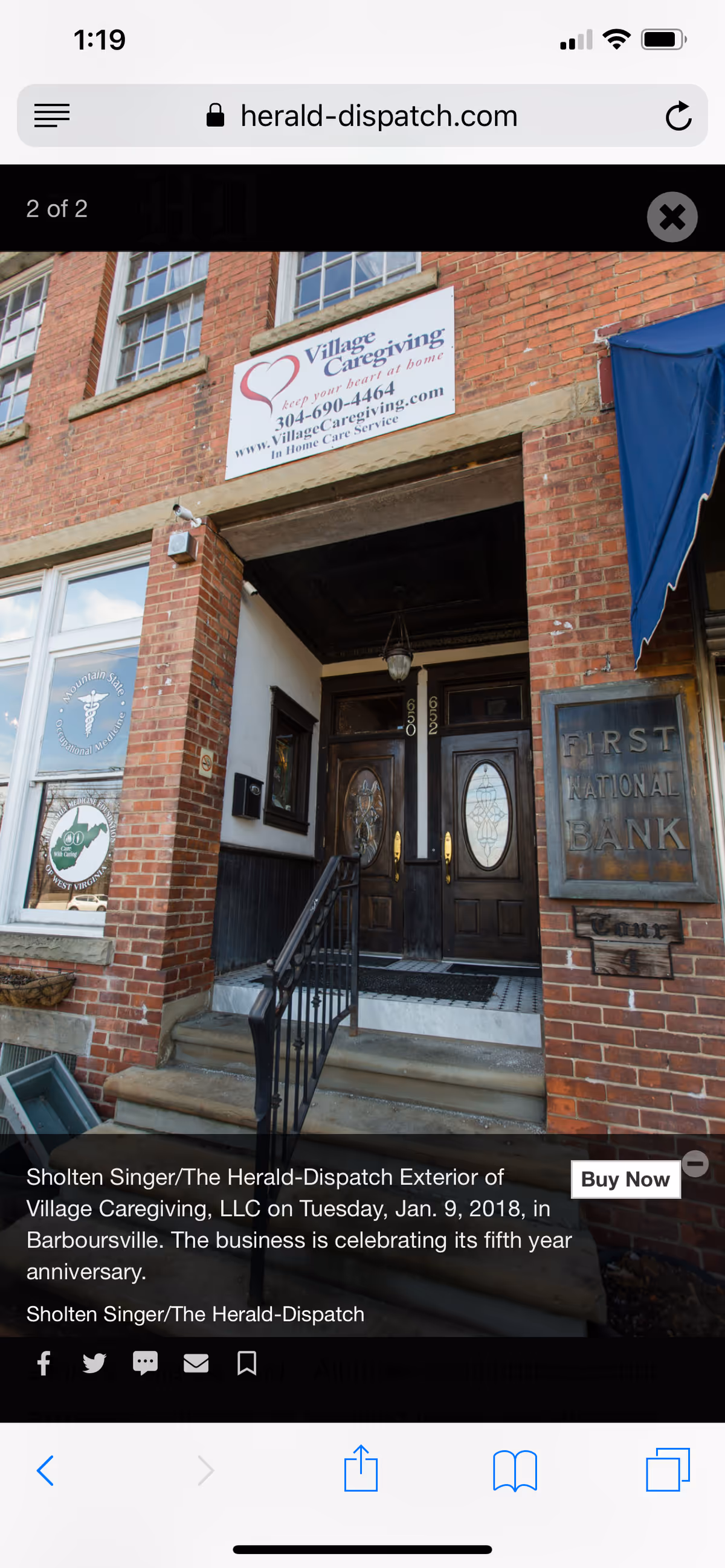 Brick building exterior with Village Caregiving sign above the entrance and steps.