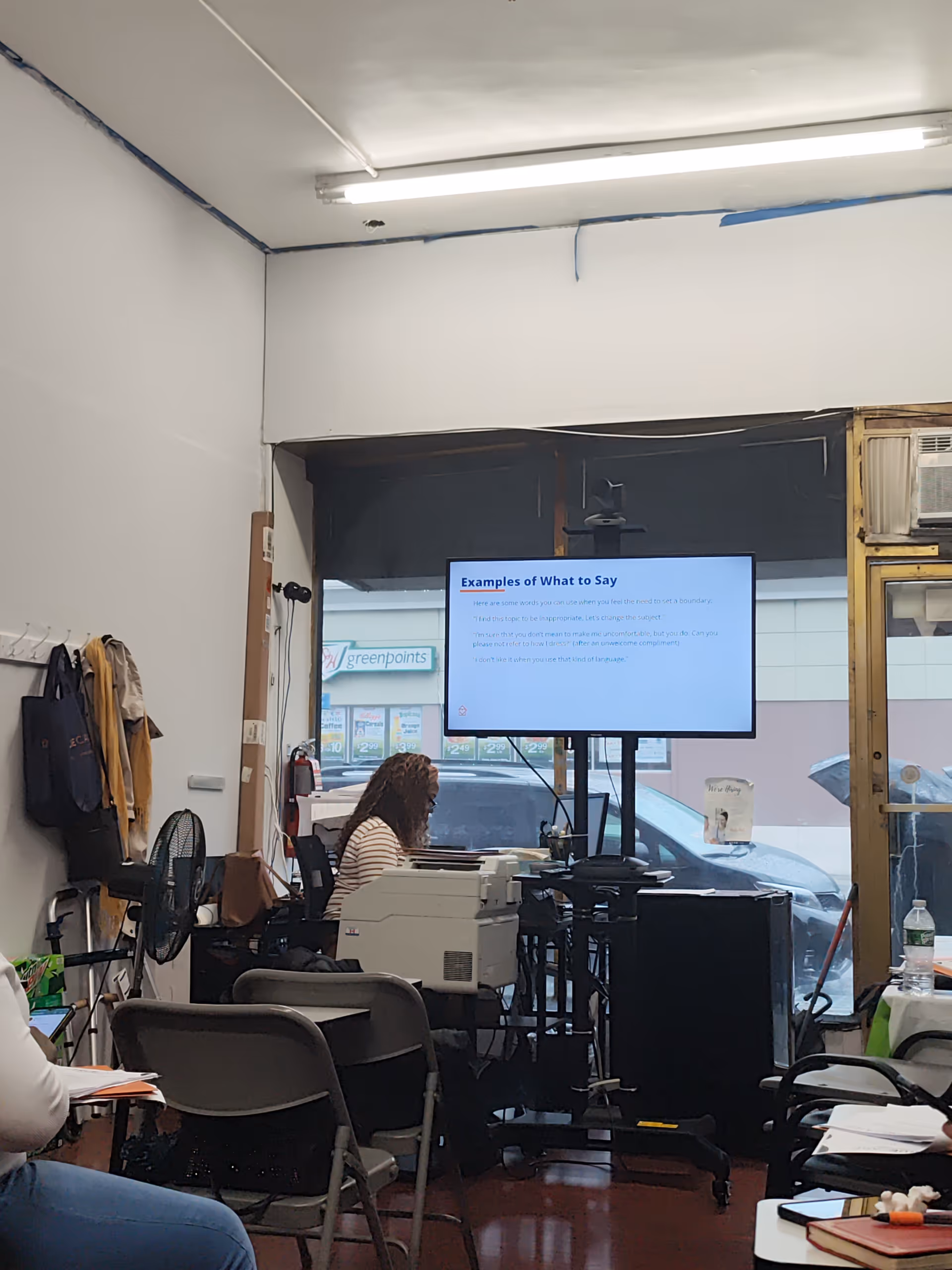 Indoor training room at a senior care facility with a presentation screen and attendees.