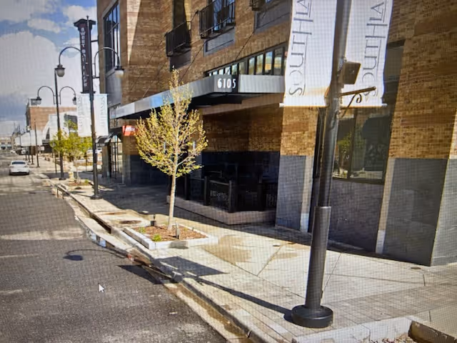Street-level view of Comfort Keepers Home Care entrance with banners and sidewalk.