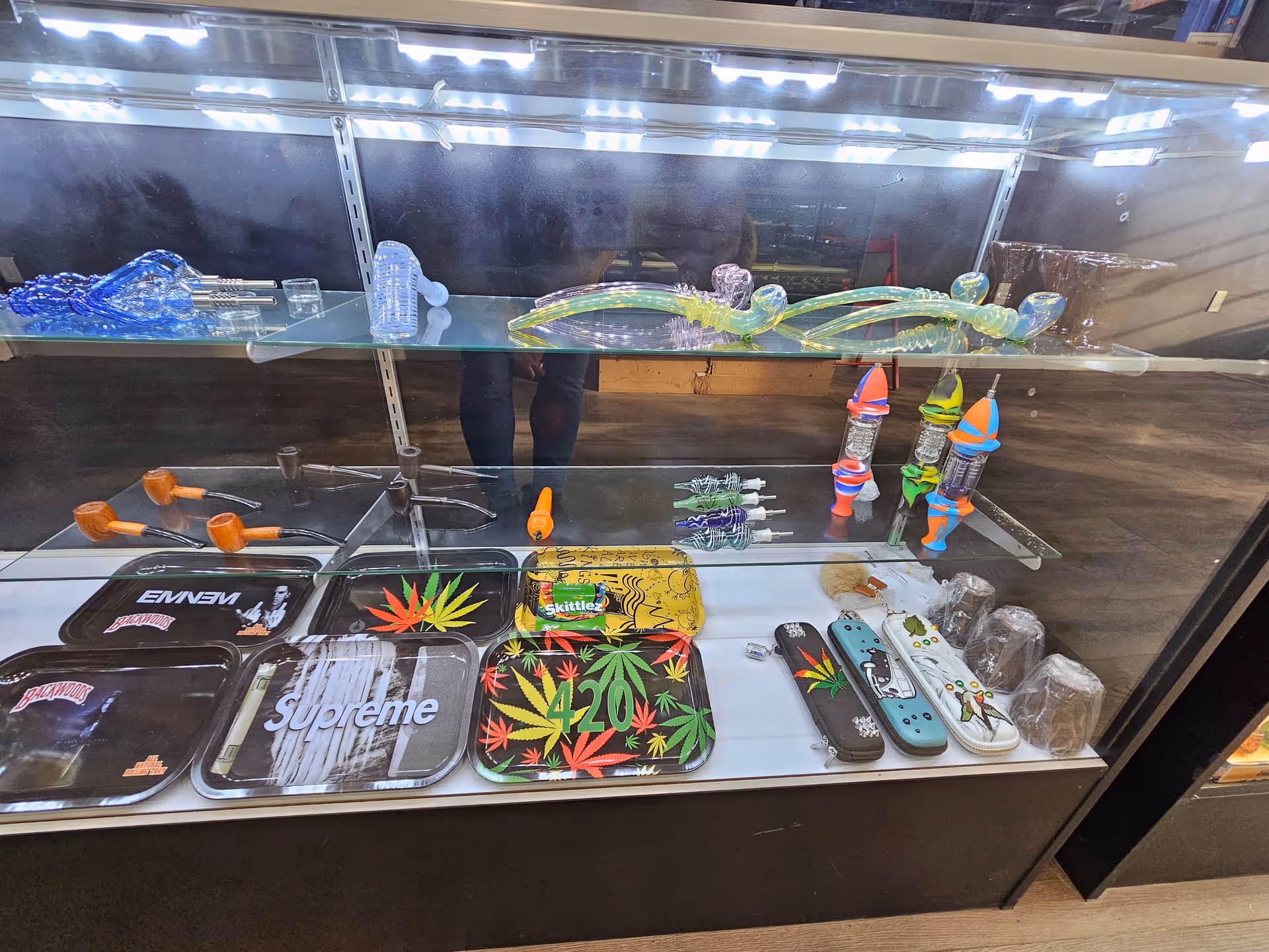 Glass display case with smoking paraphernalia and accessories inside a shop