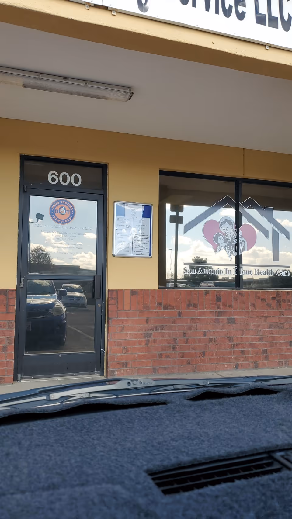 Exterior view of a storefront for San Antonio In Home Health Care, with door and window.