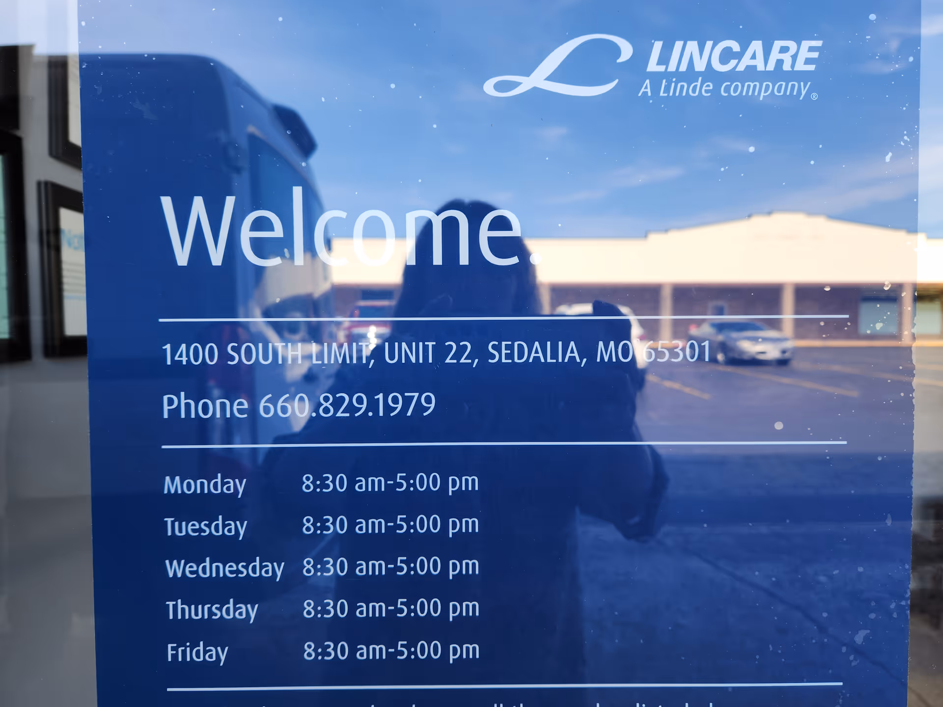 Blue glass door sign reads Welcome with Lincare logo, address, and weekly hours.