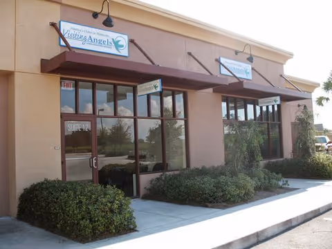 Exterior view of Visiting Angels Senior Home Care storefront with signage and landscaping.
