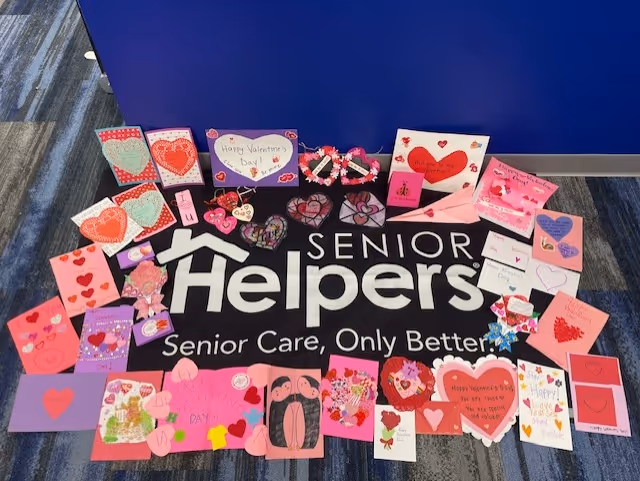Floor mat reading Senior Helpers surrounded by colorful handmade Valentine's Day cards.