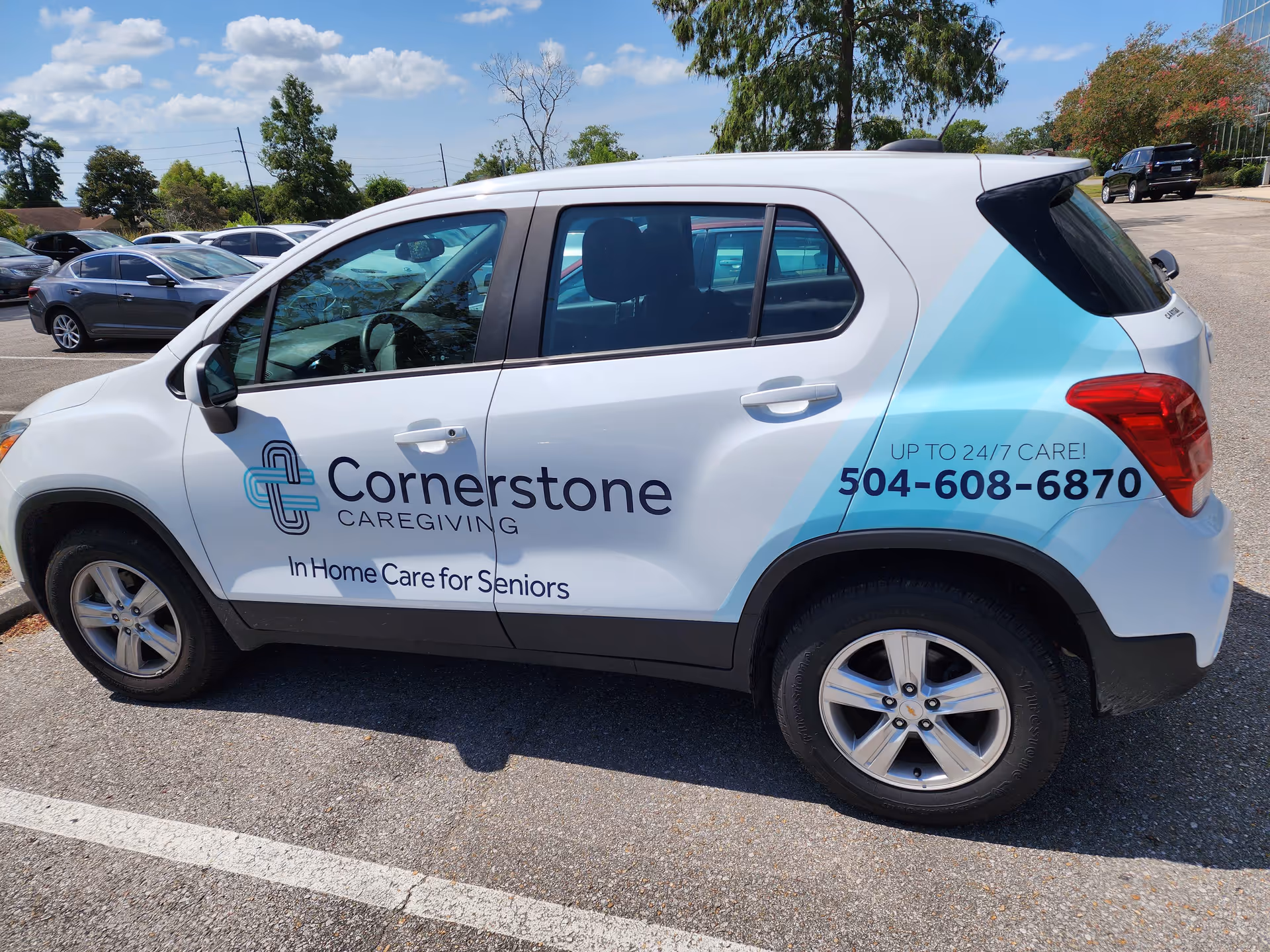 White Cornerstone Caregiving van parked in a lot with logo visible