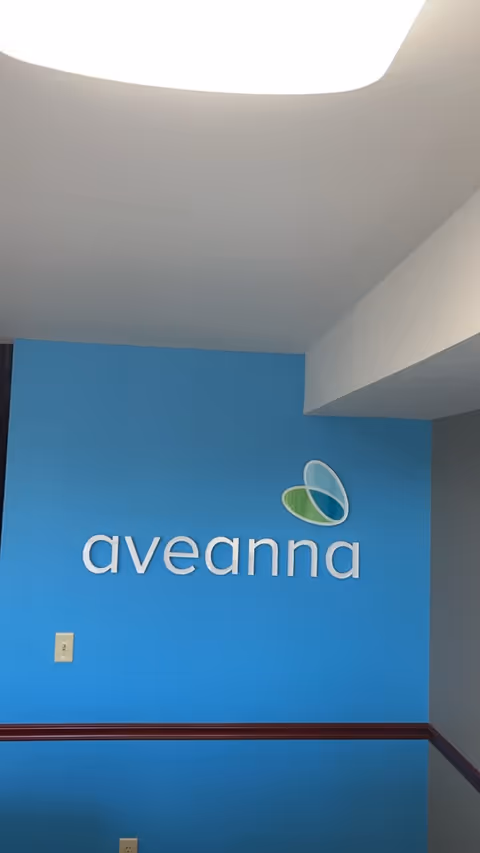 Interior wall with Aveanna Home Health logo on a blue wall.