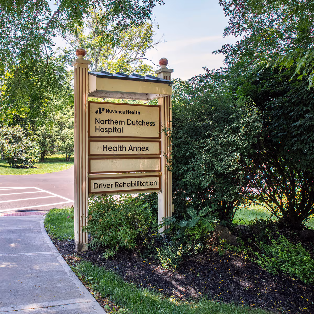 Outdoor sign displays Northern Dutchess Hospital and Health Annex with surrounding greenery.