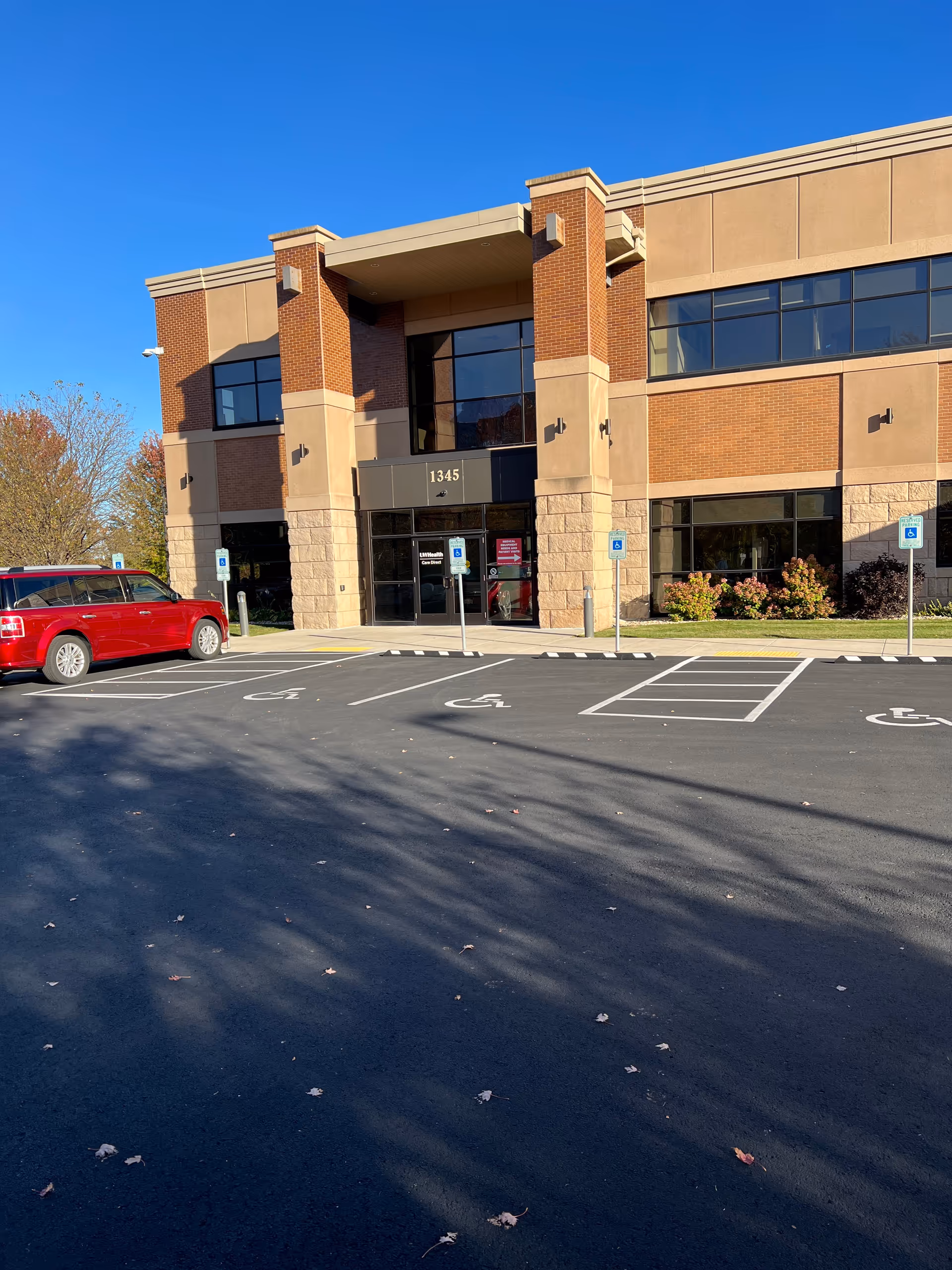 Exterior view of the UW Health Home Care Services building with a parking lot in foreground.