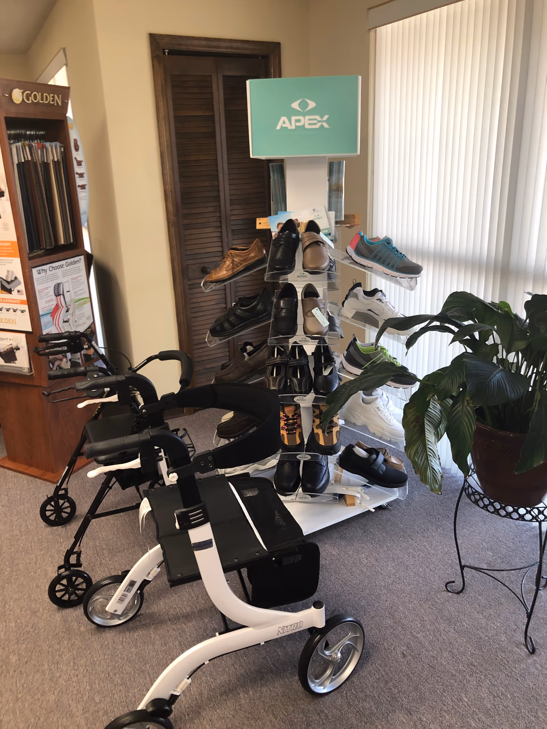 Mobility aids and shoes displayed in an interior facility showroom.