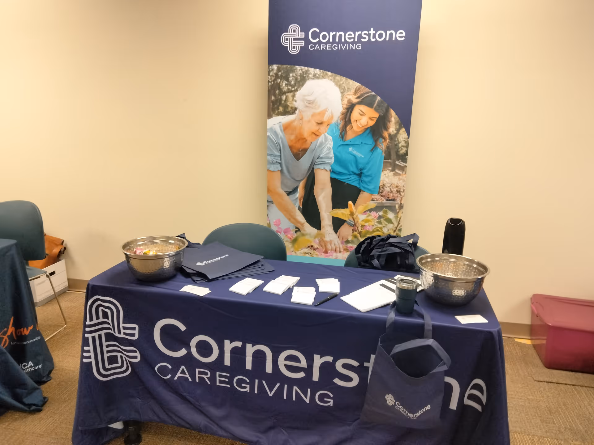 Indoor Cornerstone Caregiving information table with banner, bowls, and brochures.