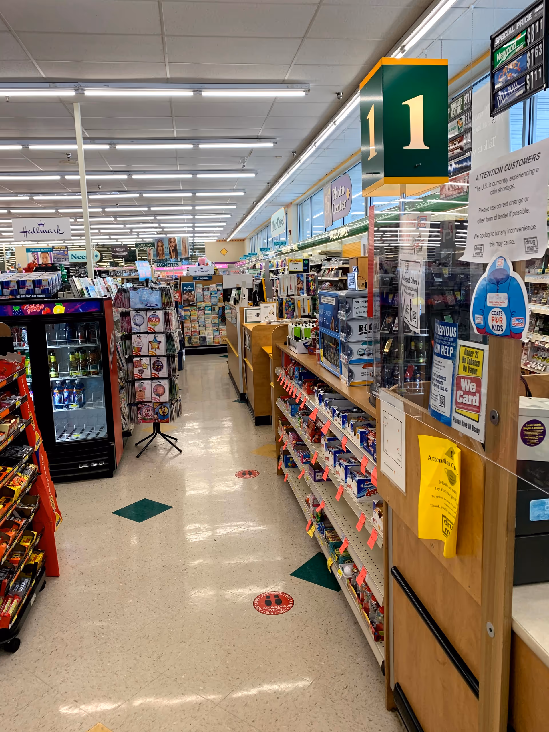 Inside a Discount Drug Mart store with aisles, shelves, and checkout areas.
