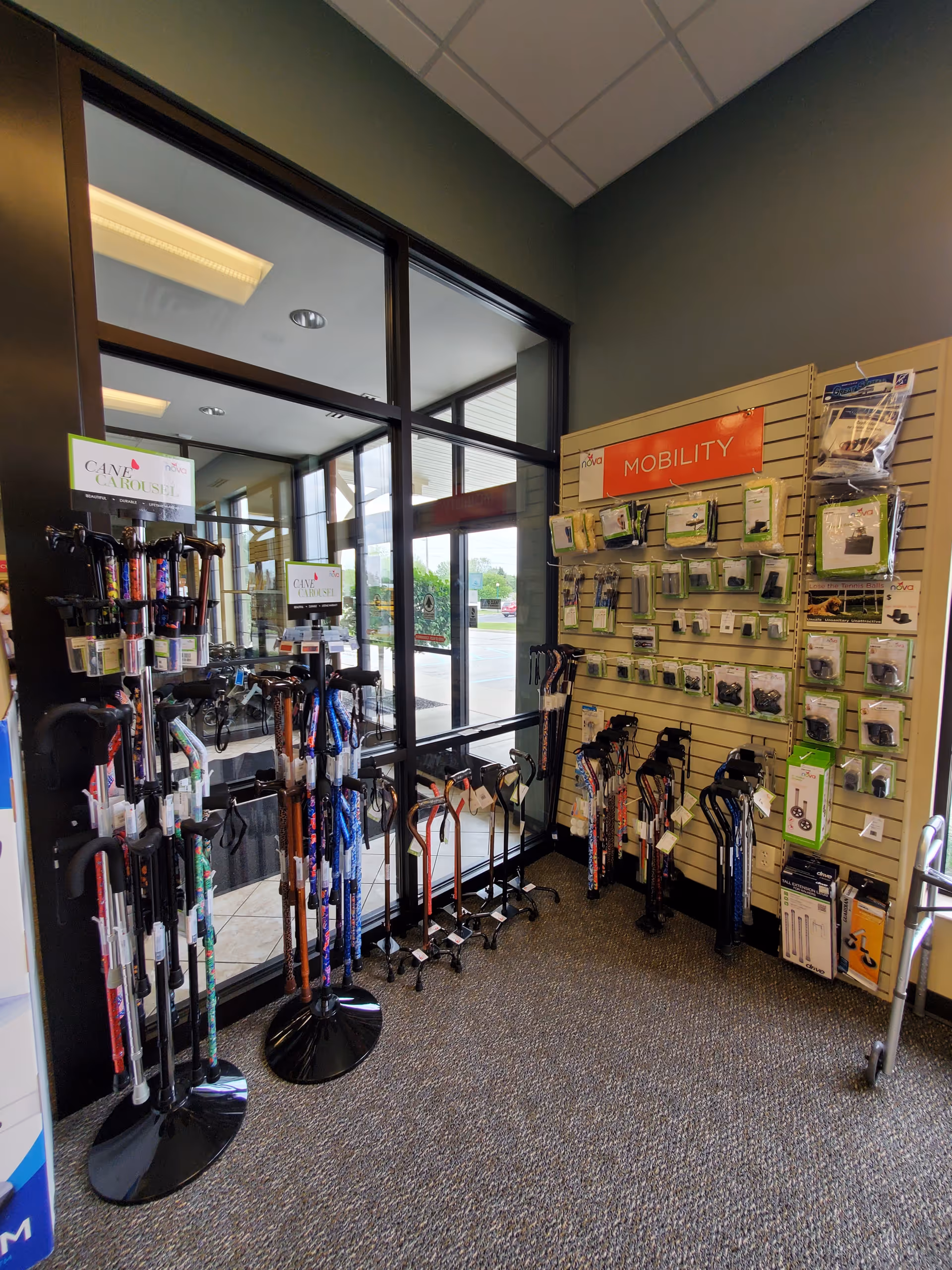 Interior showroom with various mobility aids such as canes, walkers, and accessories mounted along walls.