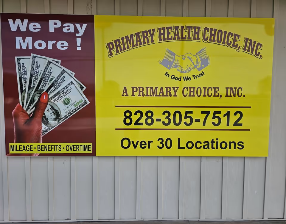 Bright yellow and maroon banner on a wooden wall advertising Primary Health Choice