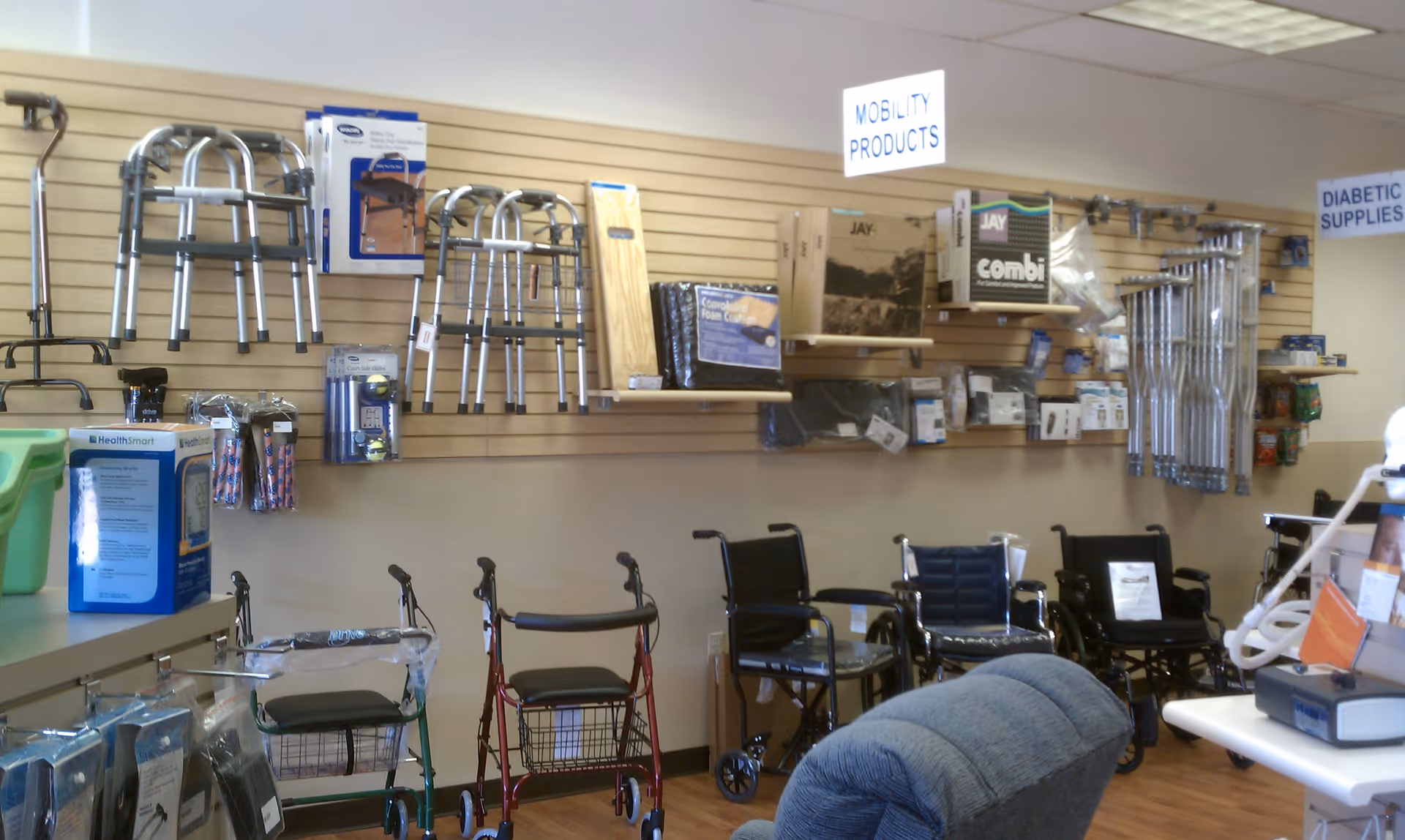 Interior medical supply showroom displaying walkers, wheelchairs, and mobility devices on shelves.