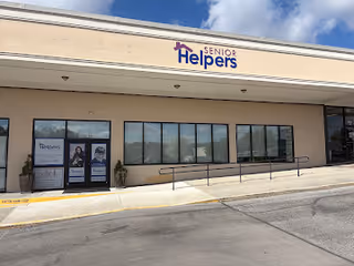 Front view of a Senior Helpers facility with large windows and a sign above.