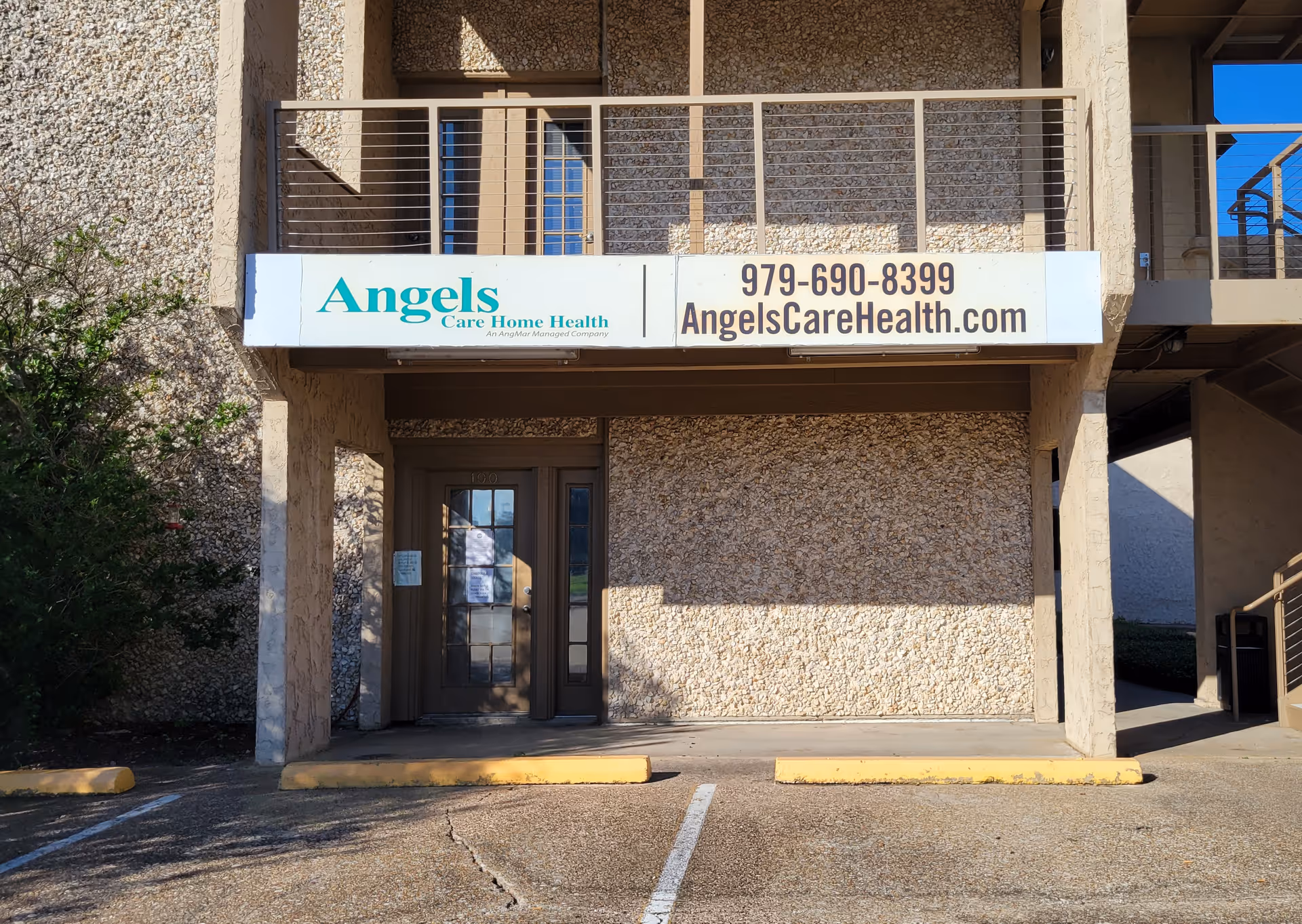 Exterior view of a building entrance for Visiting Angels Senior Home Care with signage.