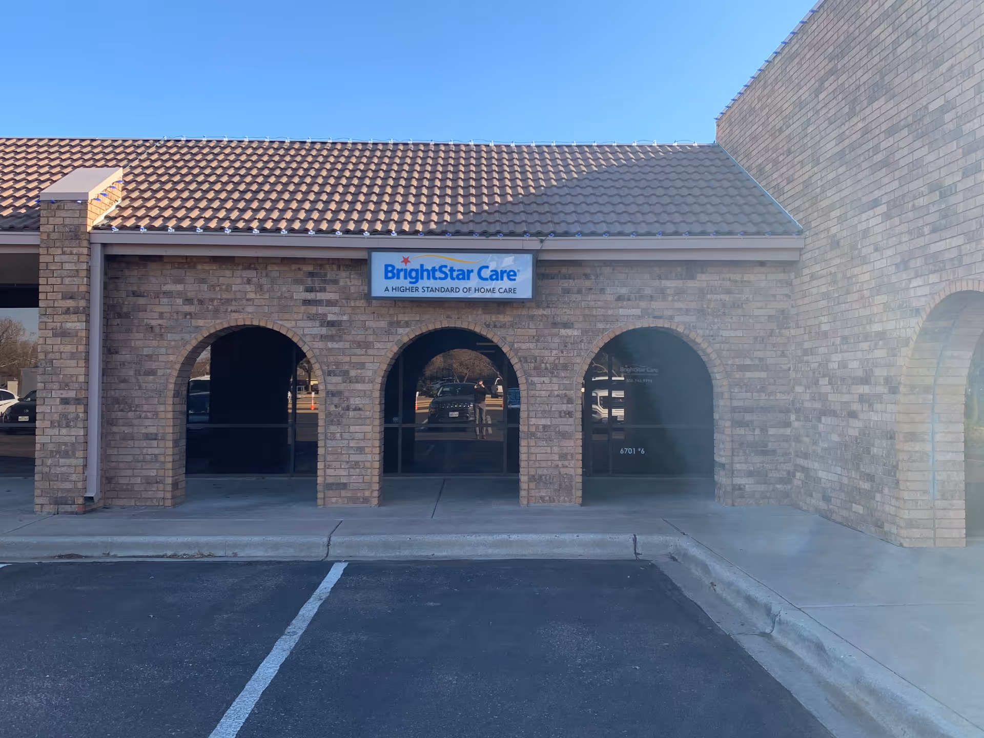 Brick storefront with arched windows and a BrightStar Care sign on the front