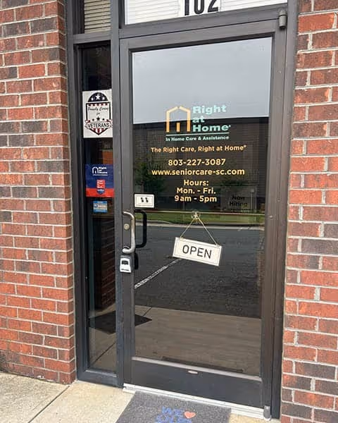 Brick exterior doorway with Right at Home logo and open sign.