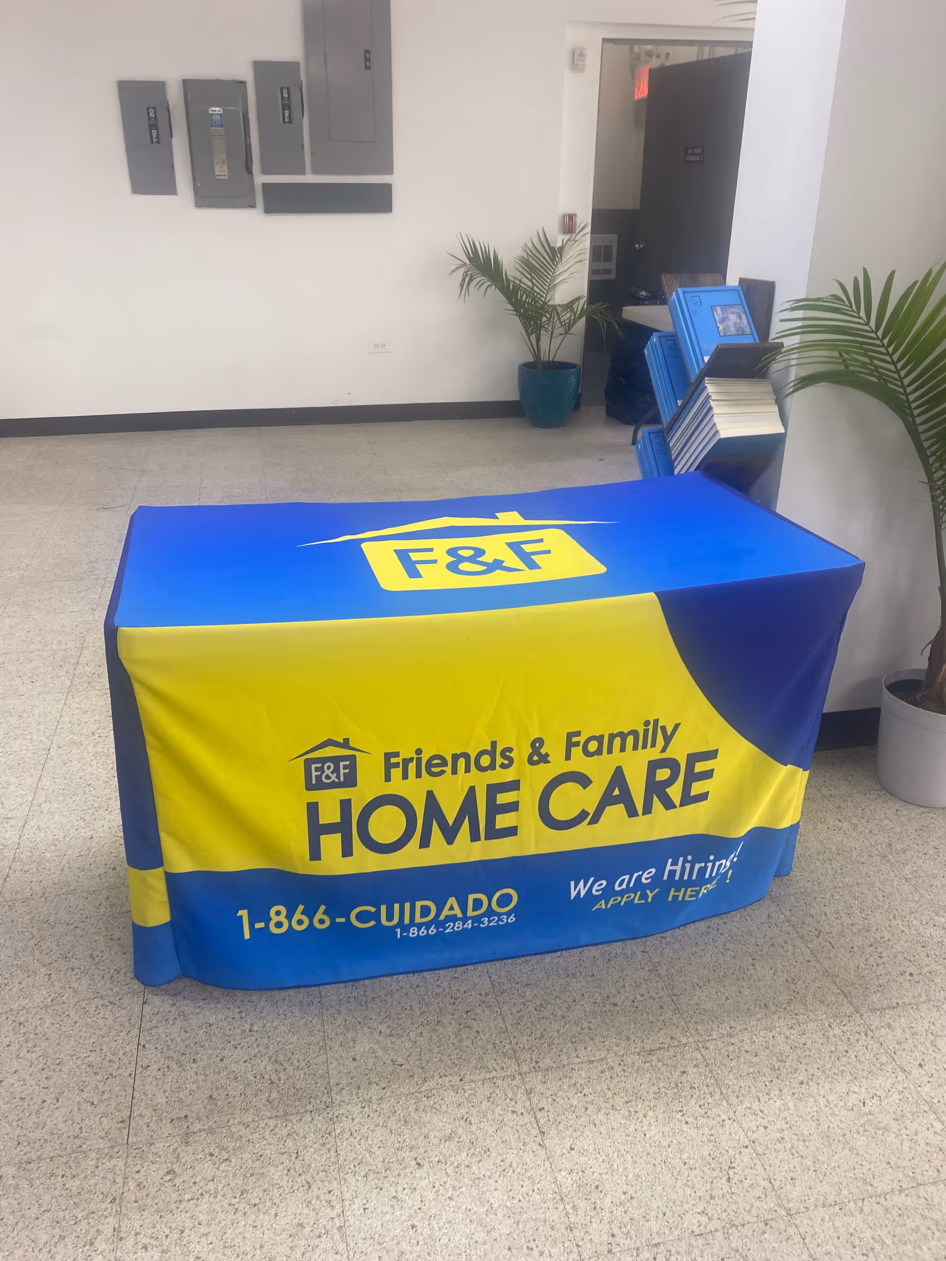 Indoor hallway with blue and yellow branded table cover for Friends & Family Home Care