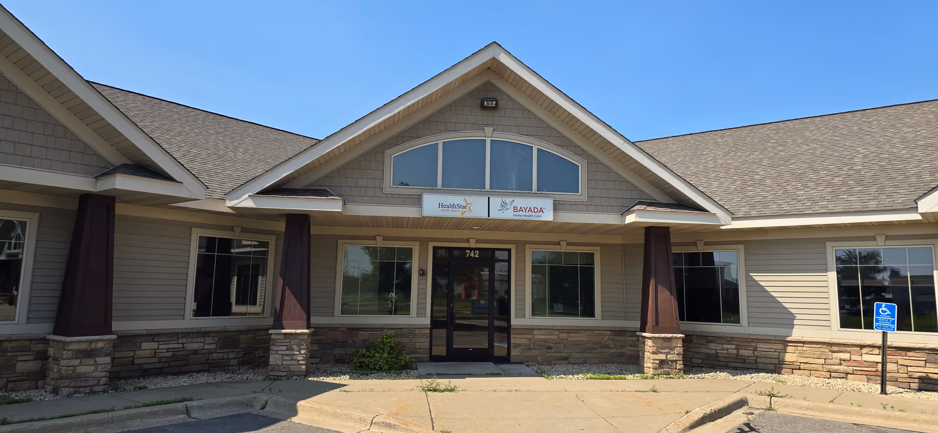 Single-story beige building with stone accents and a BAYADA Pediatrics entrance sign.
