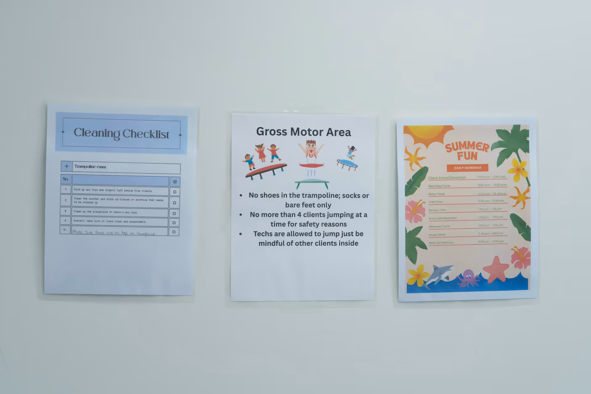 Three posters on a light wall: Cleaning checklist, Gross Motor Area, Summer Fun schedule.