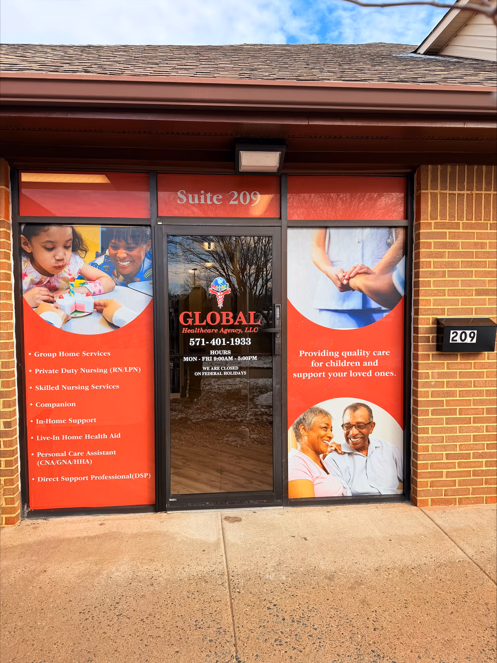 Glass storefront with red banners for Global Healthcare Agency, LLC, Suite 209.