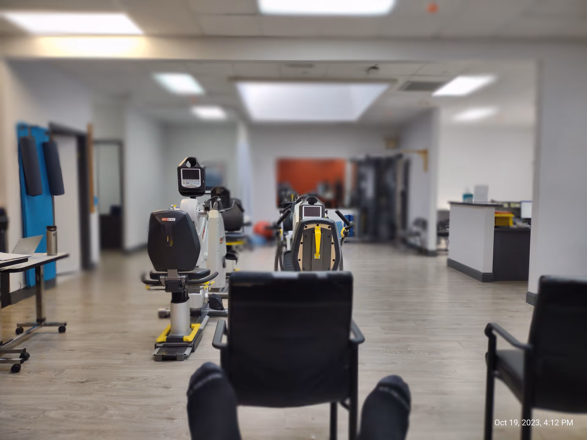 A rehabilitation gym with exercise bikes and equipment in a bright, spacious interior.