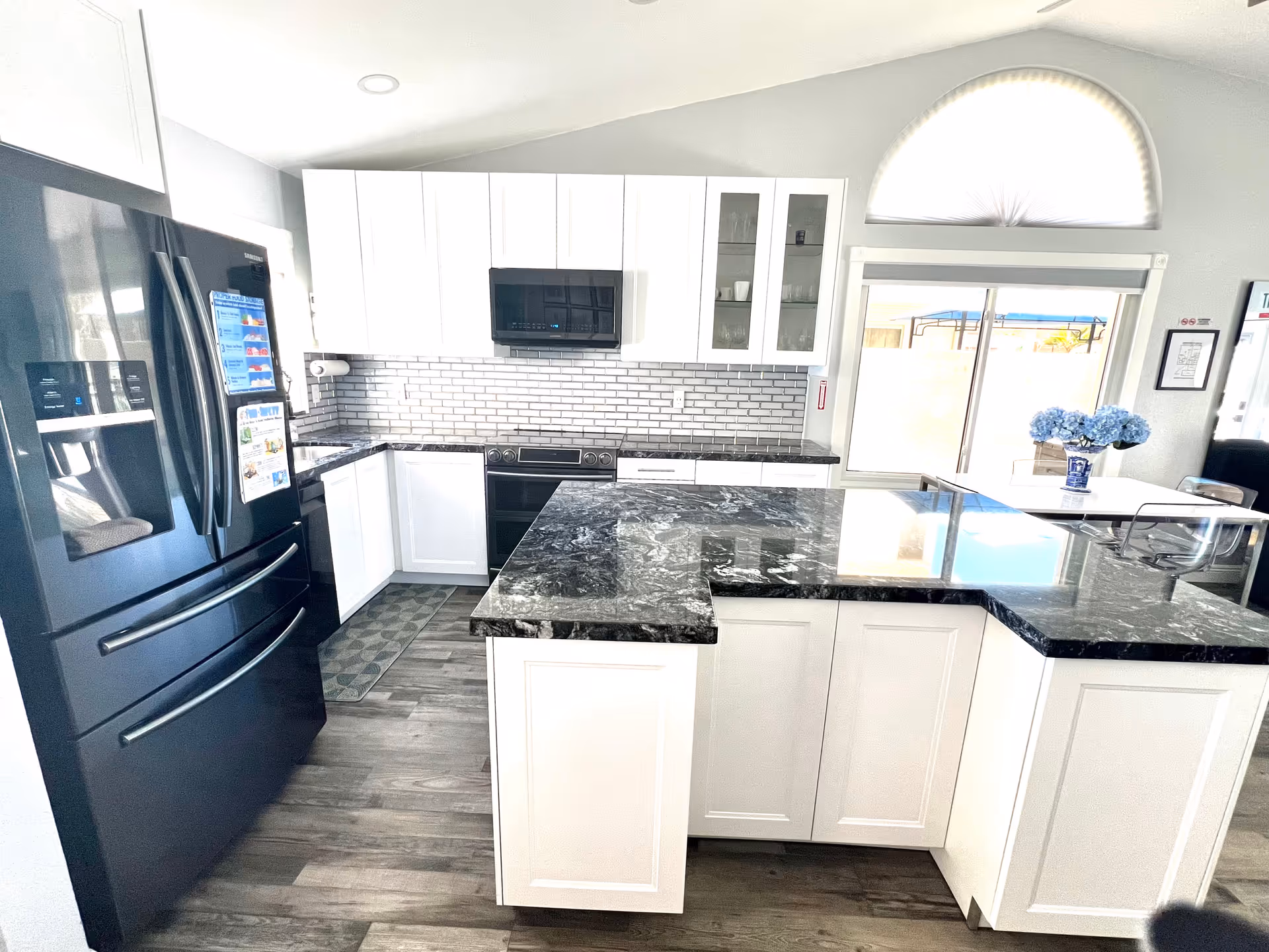 Bright, modern kitchen in Amore Healthcare with white cabinets and island.