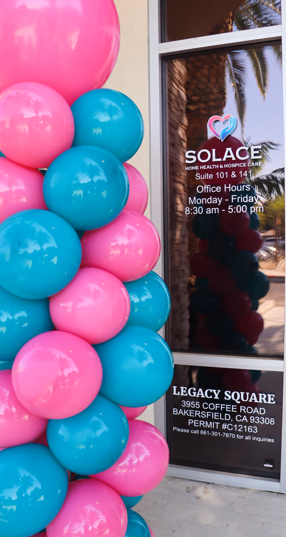 Glass entrance door with Solace logo and colorful balloons outside the facility.