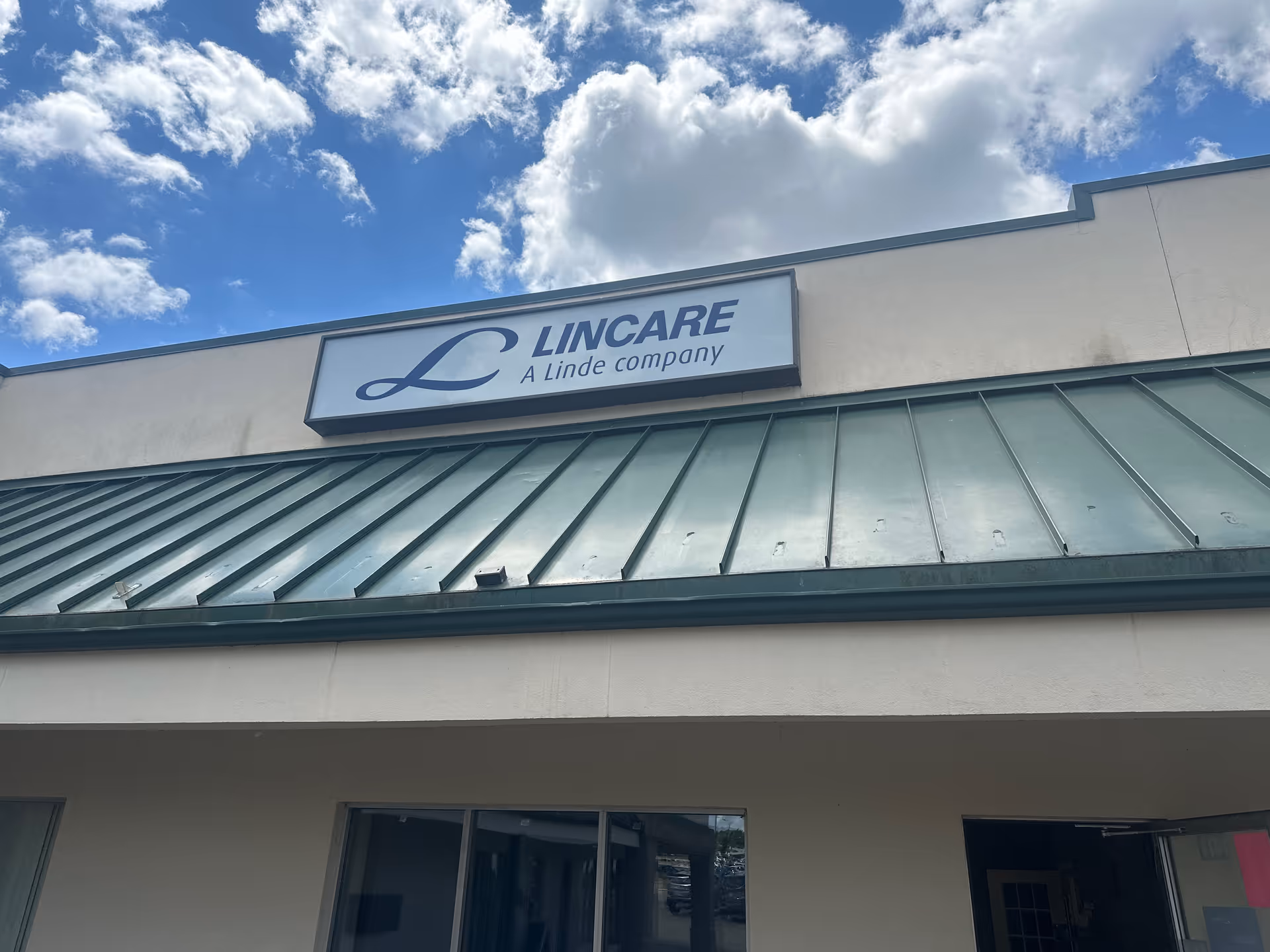 Exterior of a LINCARE senior living facility with a sign on the facade