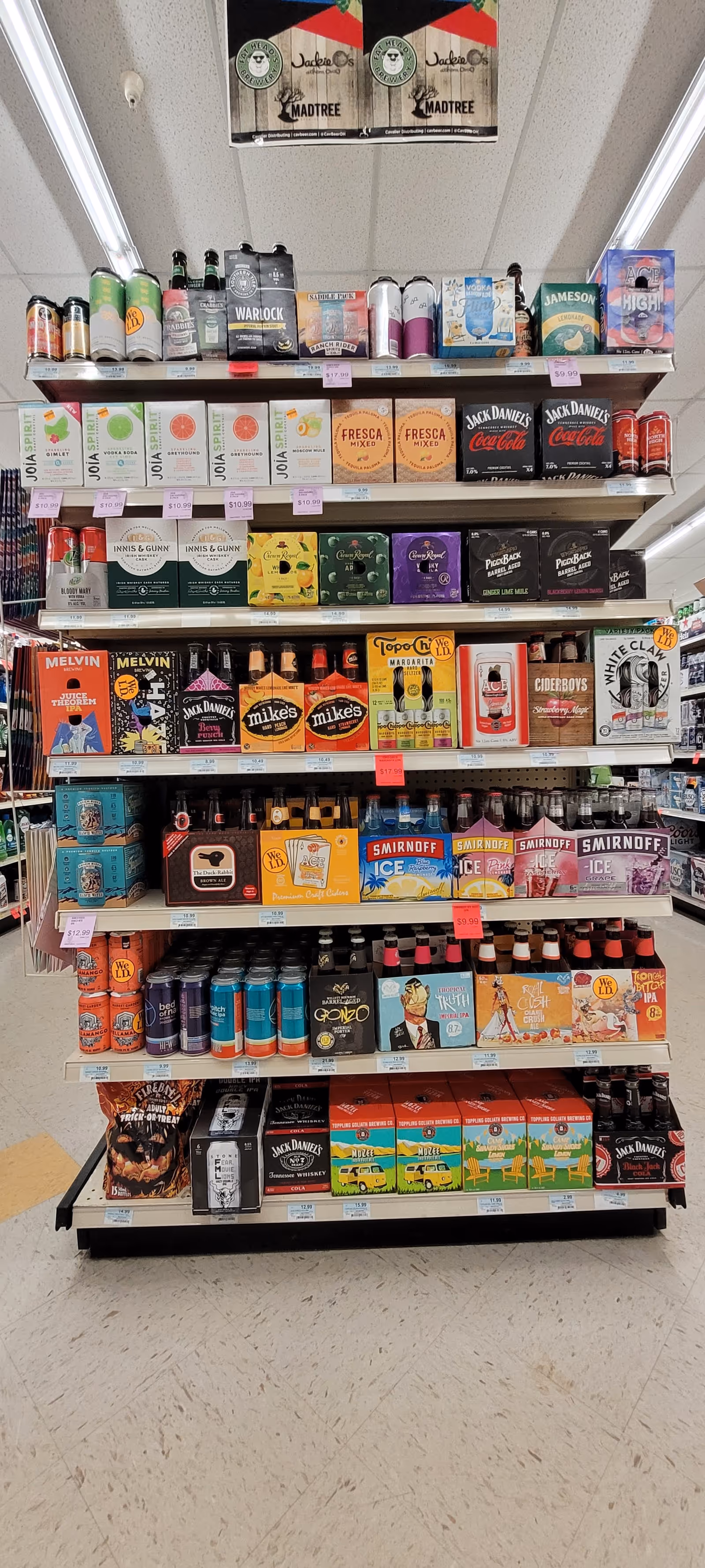 Shelves stocked with assorted beverages and alcohol inside a Discount Drug Mart store.