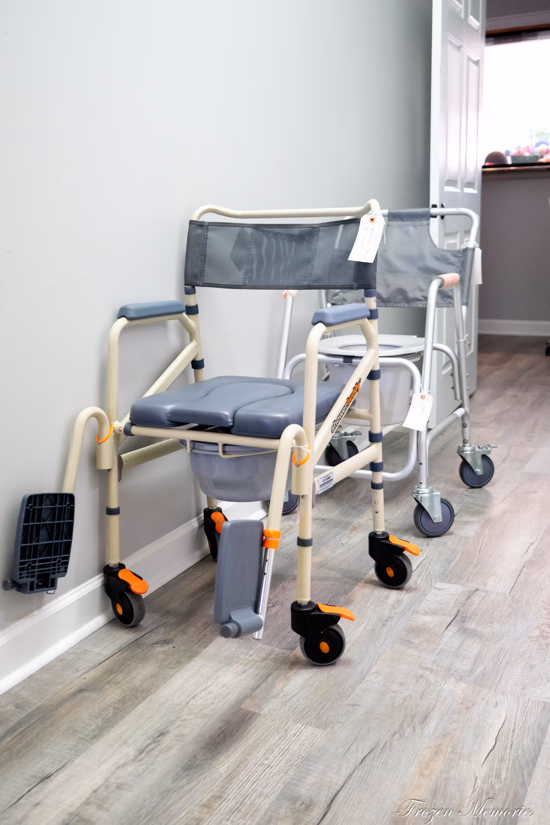 Wheelchair and mobility aids in a hallway at a senior care facility.