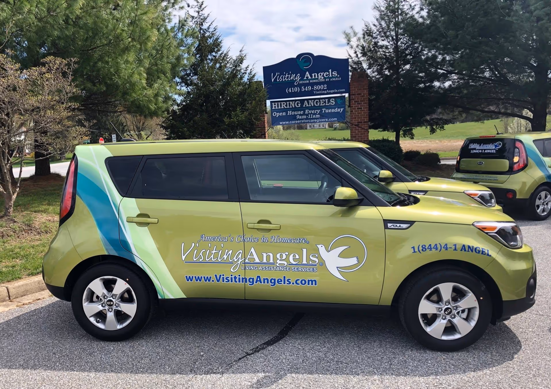 Two lime-green Visiting Angels vans parked near the Annapolis facility sign.