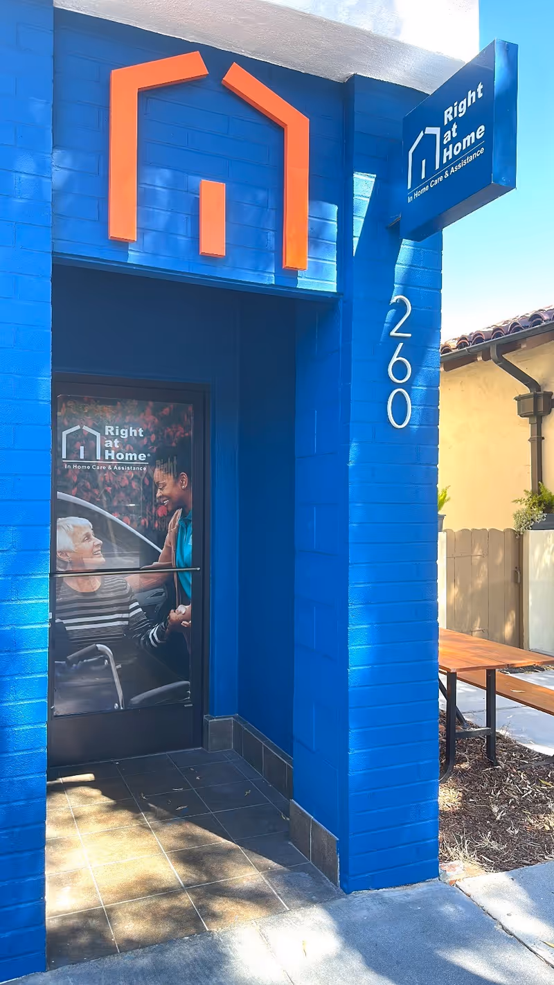 Bright blue building exterior featuring a Right at Home entrance and storefront sign.